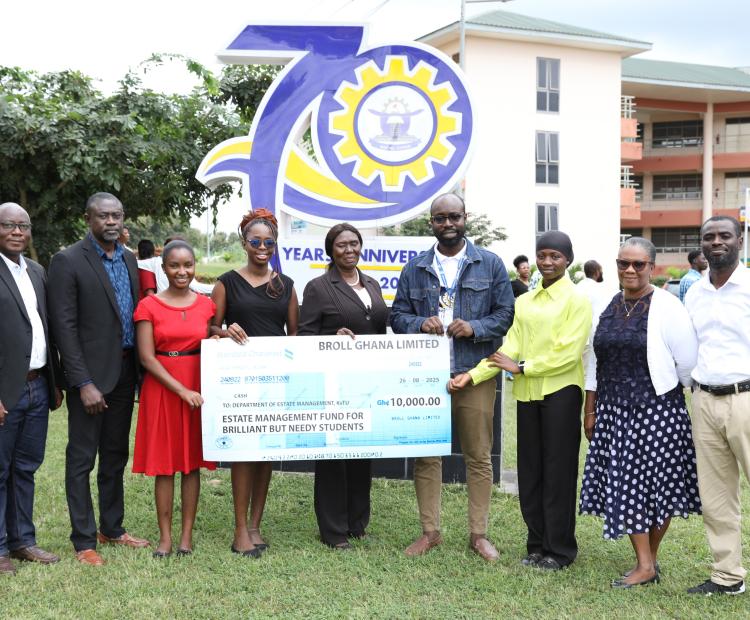 Mr. Emmanuel Okoh (2nd from left), Manager of Kumasi City Mall, presenting a cheque of GHS 10,000 on behalf of Broll Ghana Limited to support brilliant but needy students in the Department of Estate Management, KsTU. Also in the photo is Dr. Lewis Abedi Asante (4th from right), Head of Department, together with the two beneficiaries (in red and yellow) and staff of the department after the presentation.